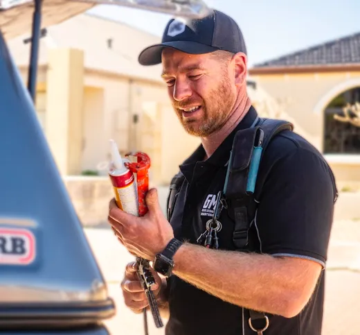 Tradie smiling in high-visibility vest
